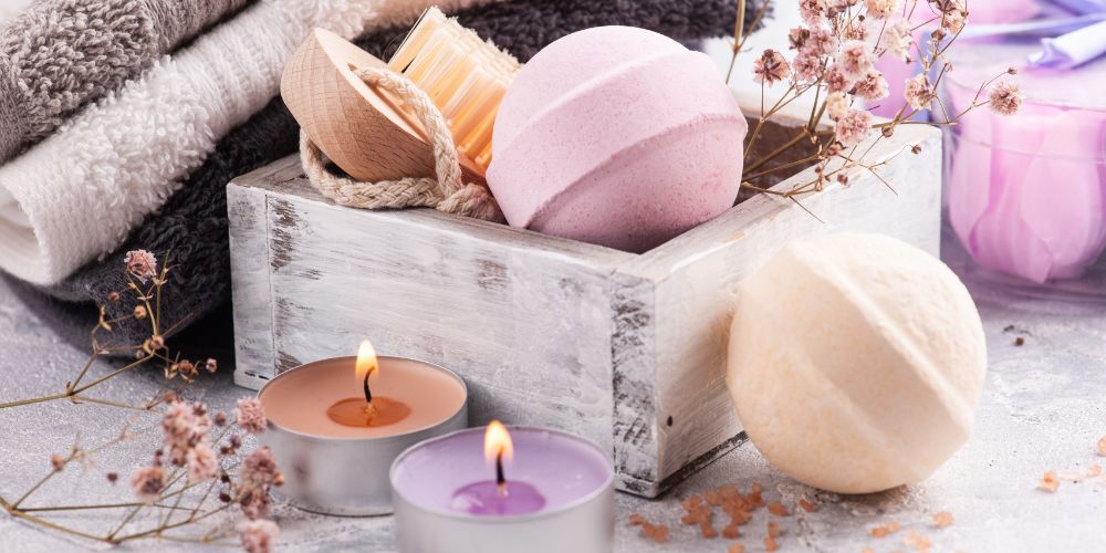 a wooden box with bath bombs and  lit candles for a serene photo