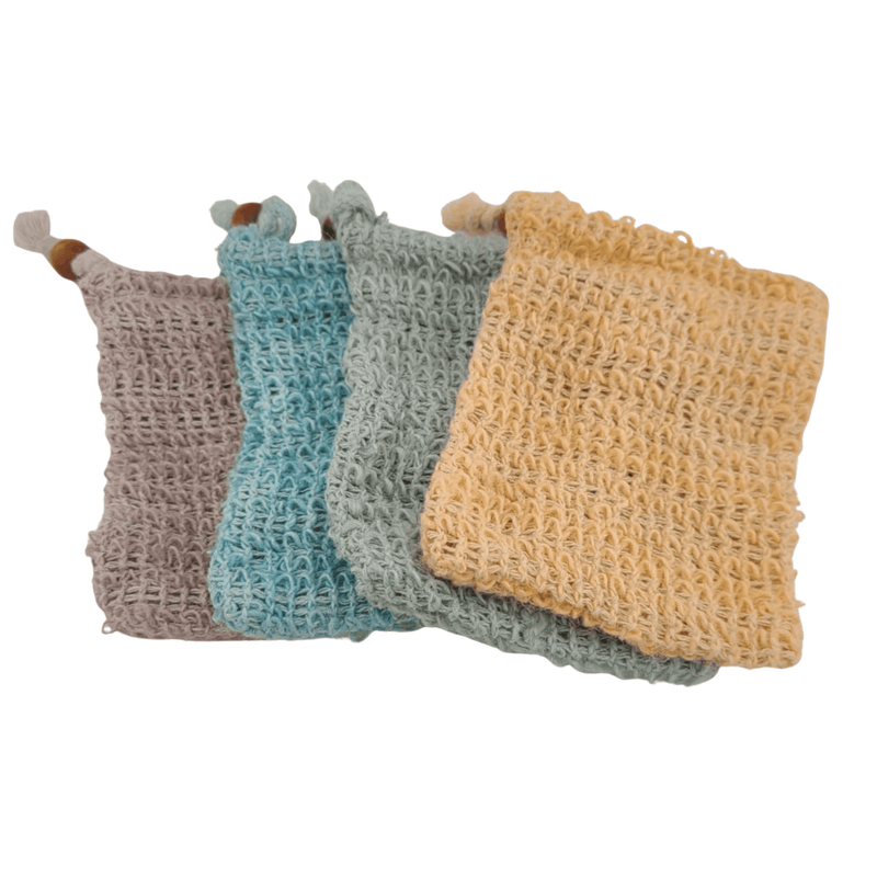 Four woven soap savers in different colors on a white background