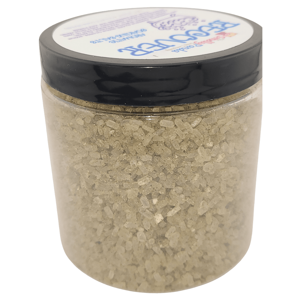 Clear jar with black lid containing a light brown powder on a white background
